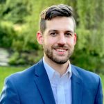 Nick in a blue suit outside.