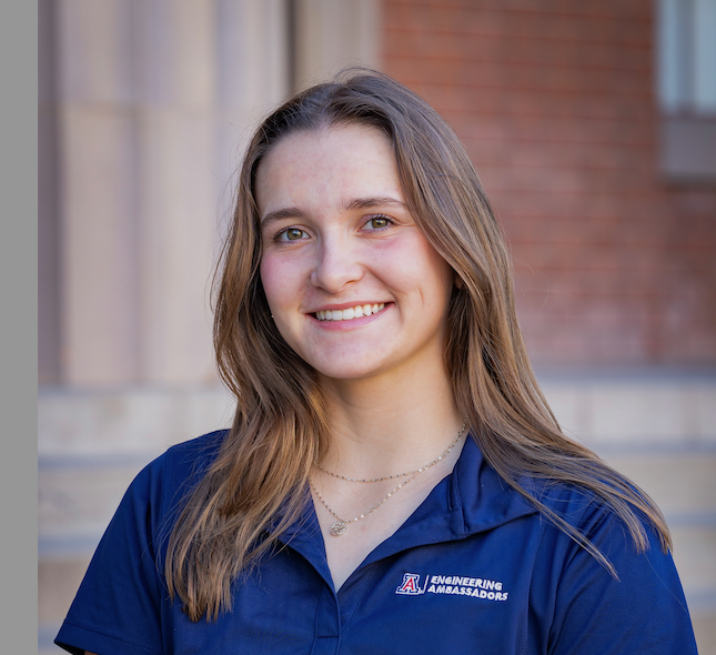 Mirina standing outside in a blue t-shirt.