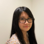 Lay facing the side with her head turned to the camera.