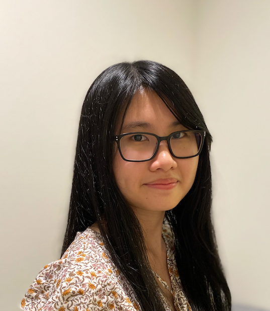 Lay facing the side with her head turned to the camera.