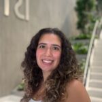 Katerina in front of a white staircase.