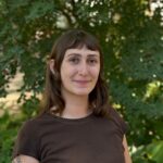 Elena outside in front of a tree.