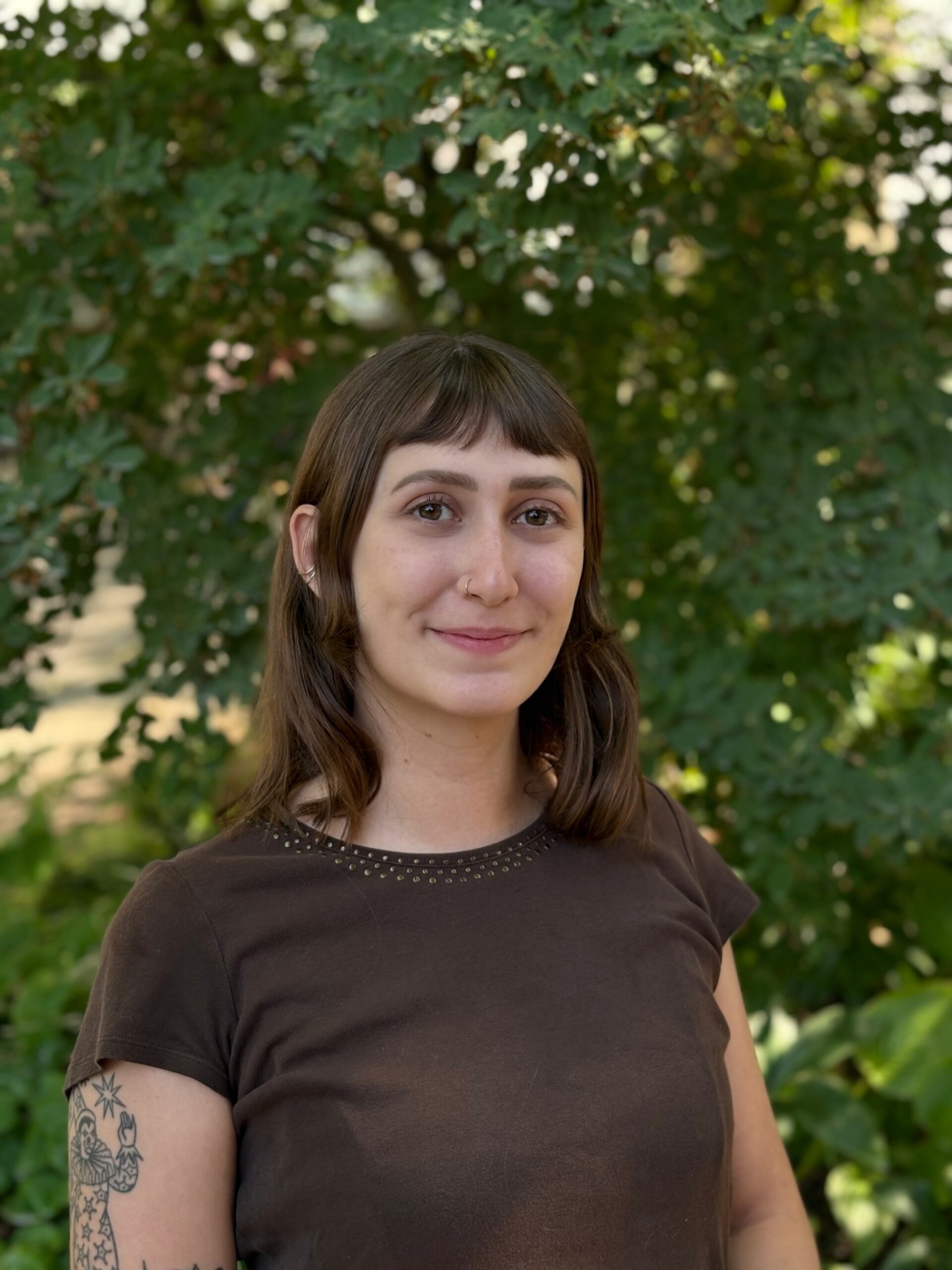 Elena outside in front of a tree.